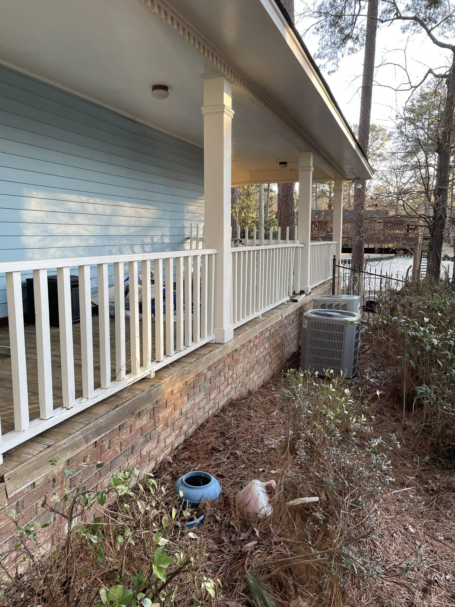 Same brick wall and white railing — clean and bright after pressure washing