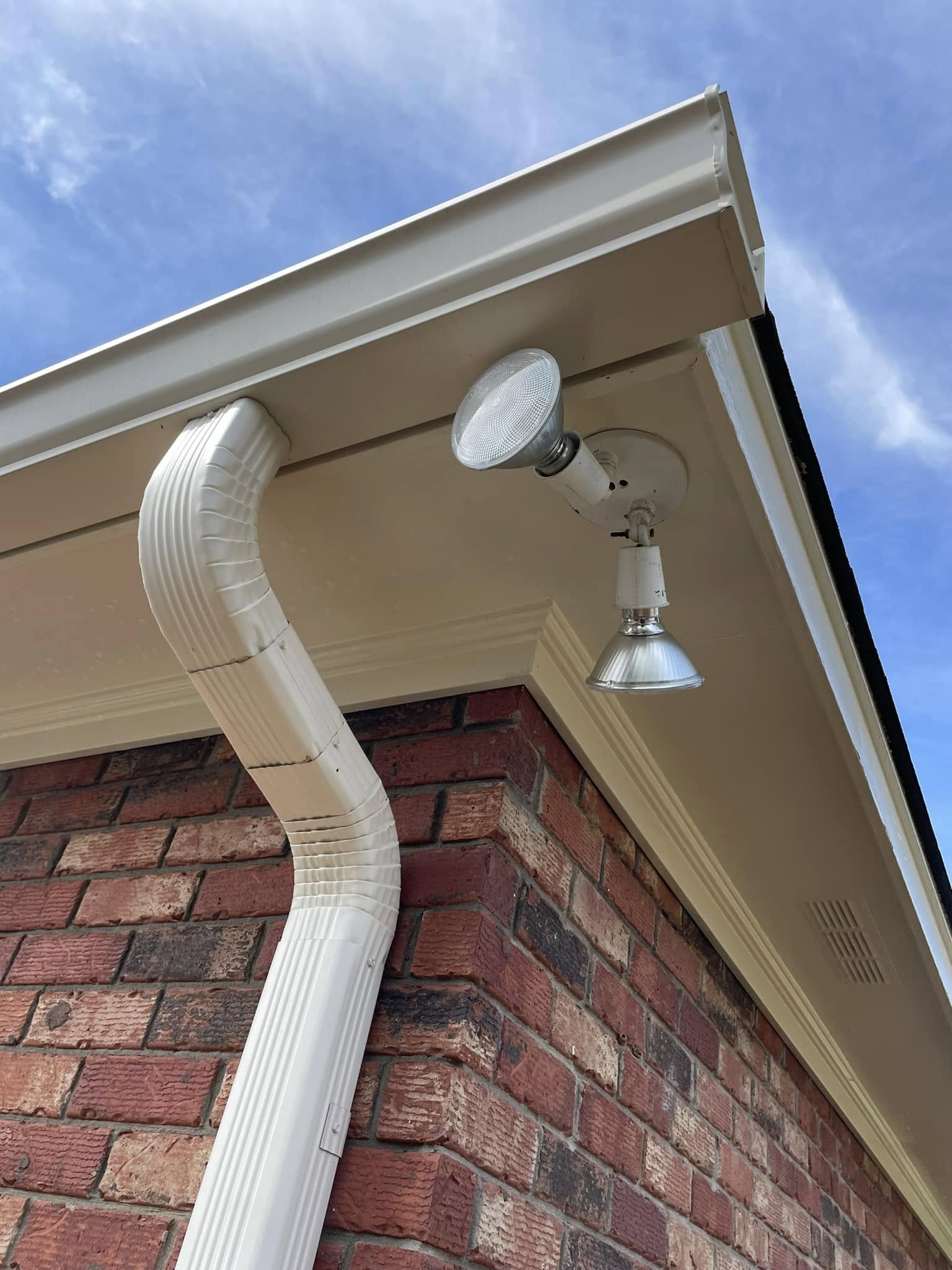 Same fascia, gutter, and brick — clean and bright after pressure washing